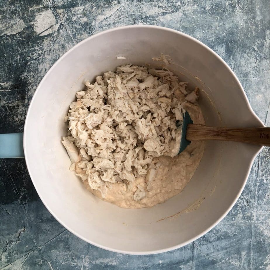 mixing bowl containing dip ingredients with crab added