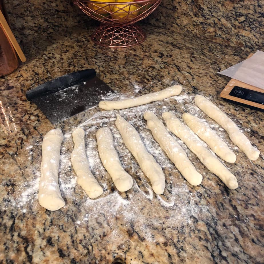 pretzel dough rolled into ropes before being cut into small pieces