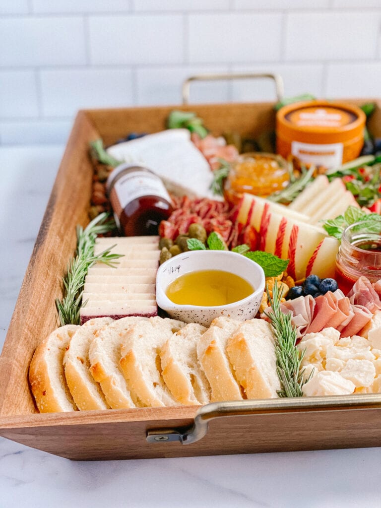 Clif Family inspired cheeseboard with some of their food items, cheeses, meats & fresh fruit