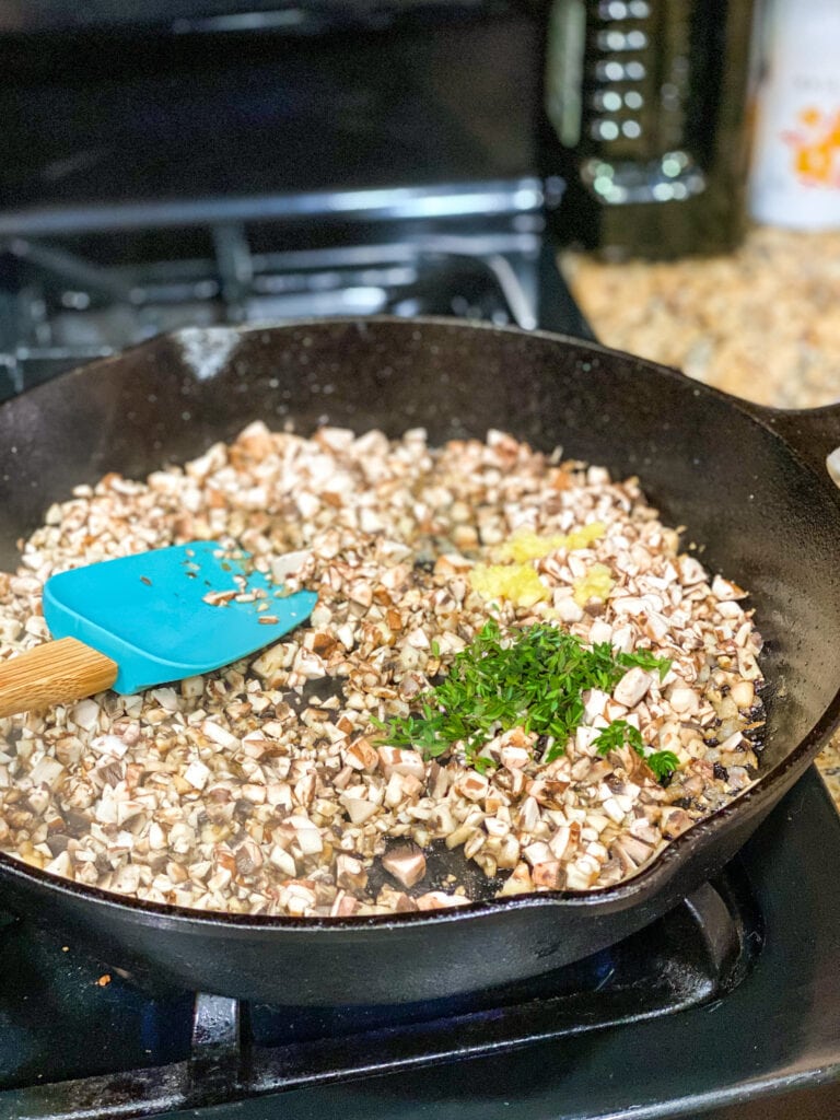 mushroom mix cooking in cast iron skillet